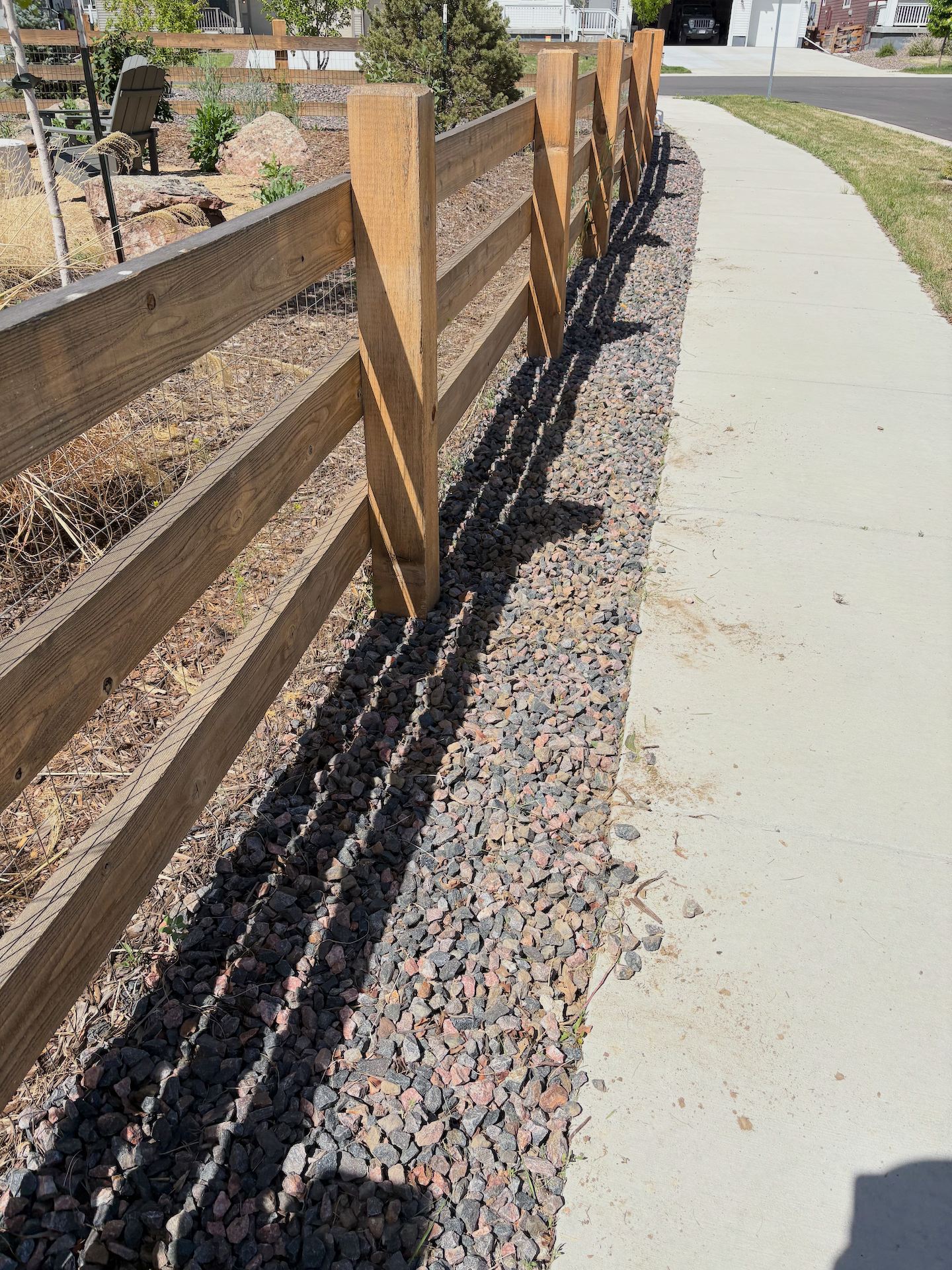 Clean fence line with rock weed barrier and plantings